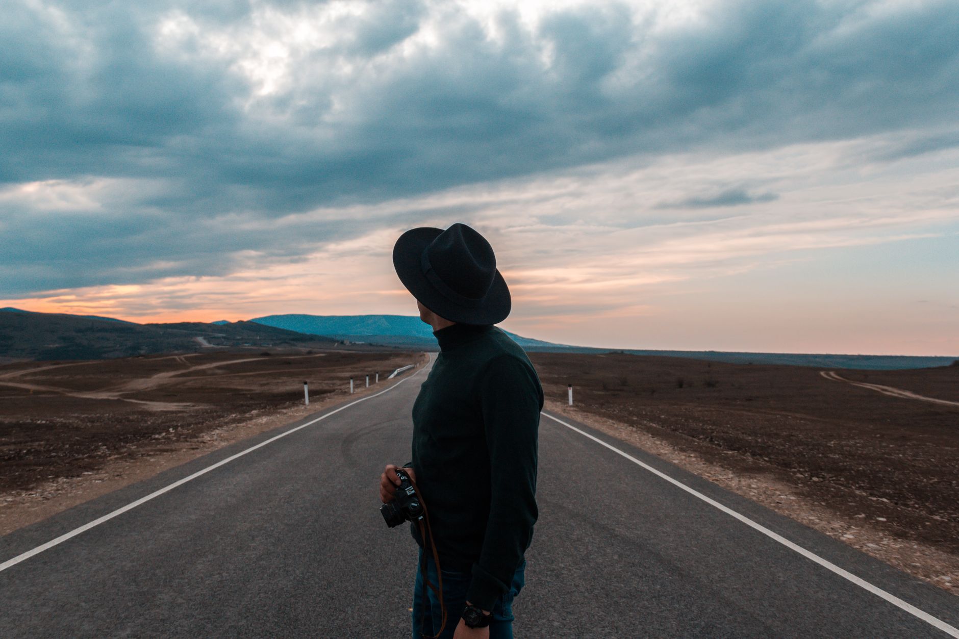 Photographer overlooking mountain horizon with camera