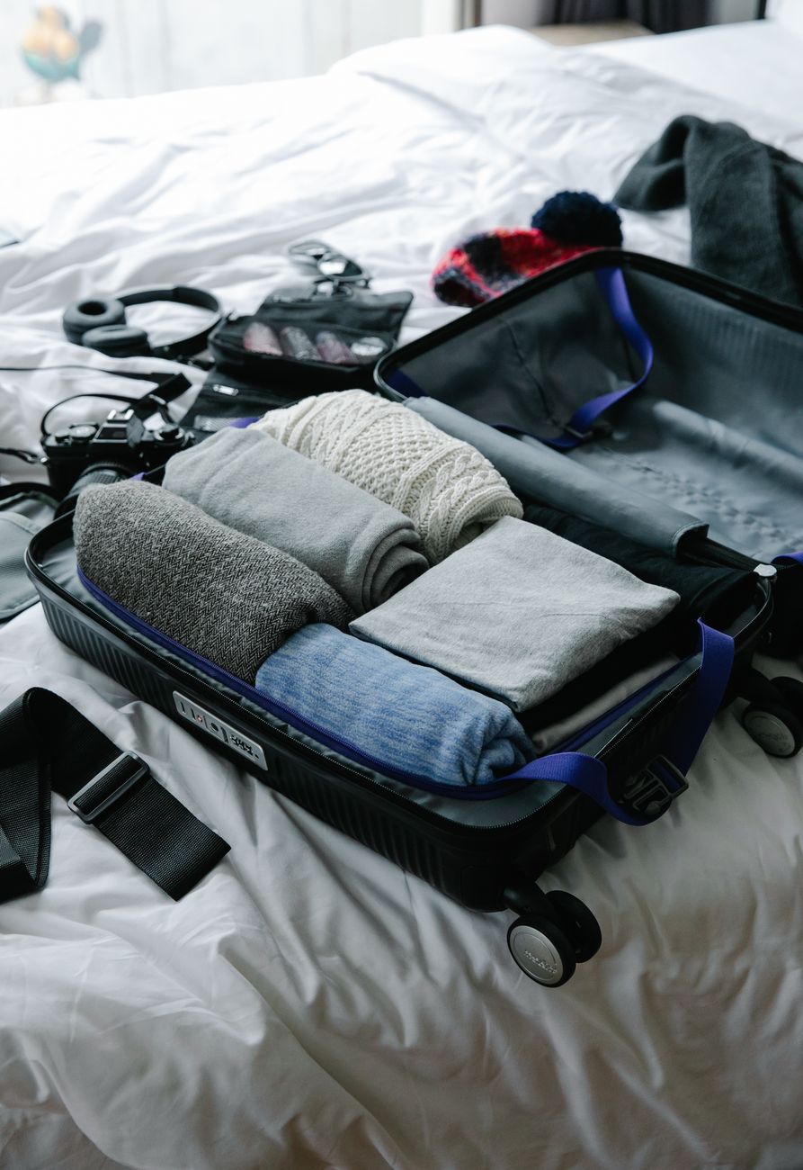 Neatly organized travel pack with camera notebook and merino wool apparel